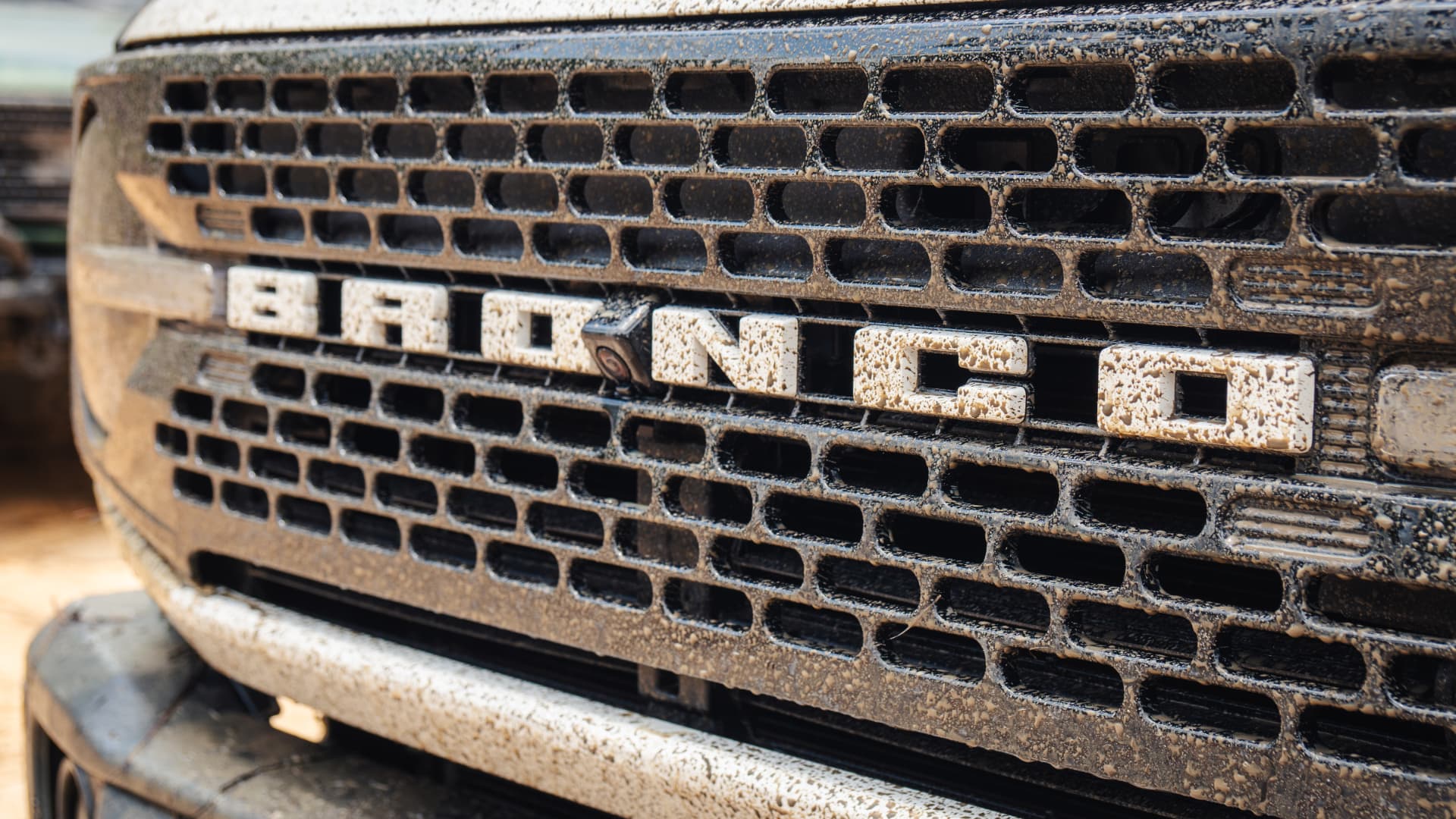 Detail of the BRONCO lettering across the dusty front grille