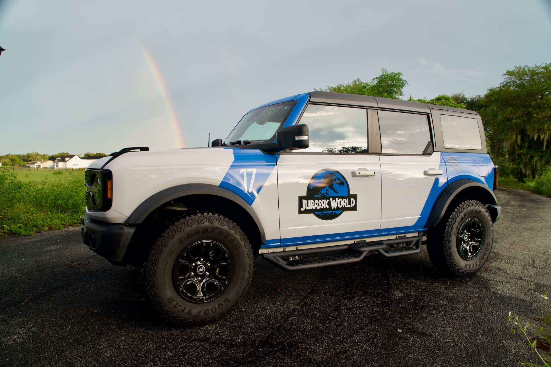 Driver side profile of the Bronco Wildtrak with a rainbow in the background