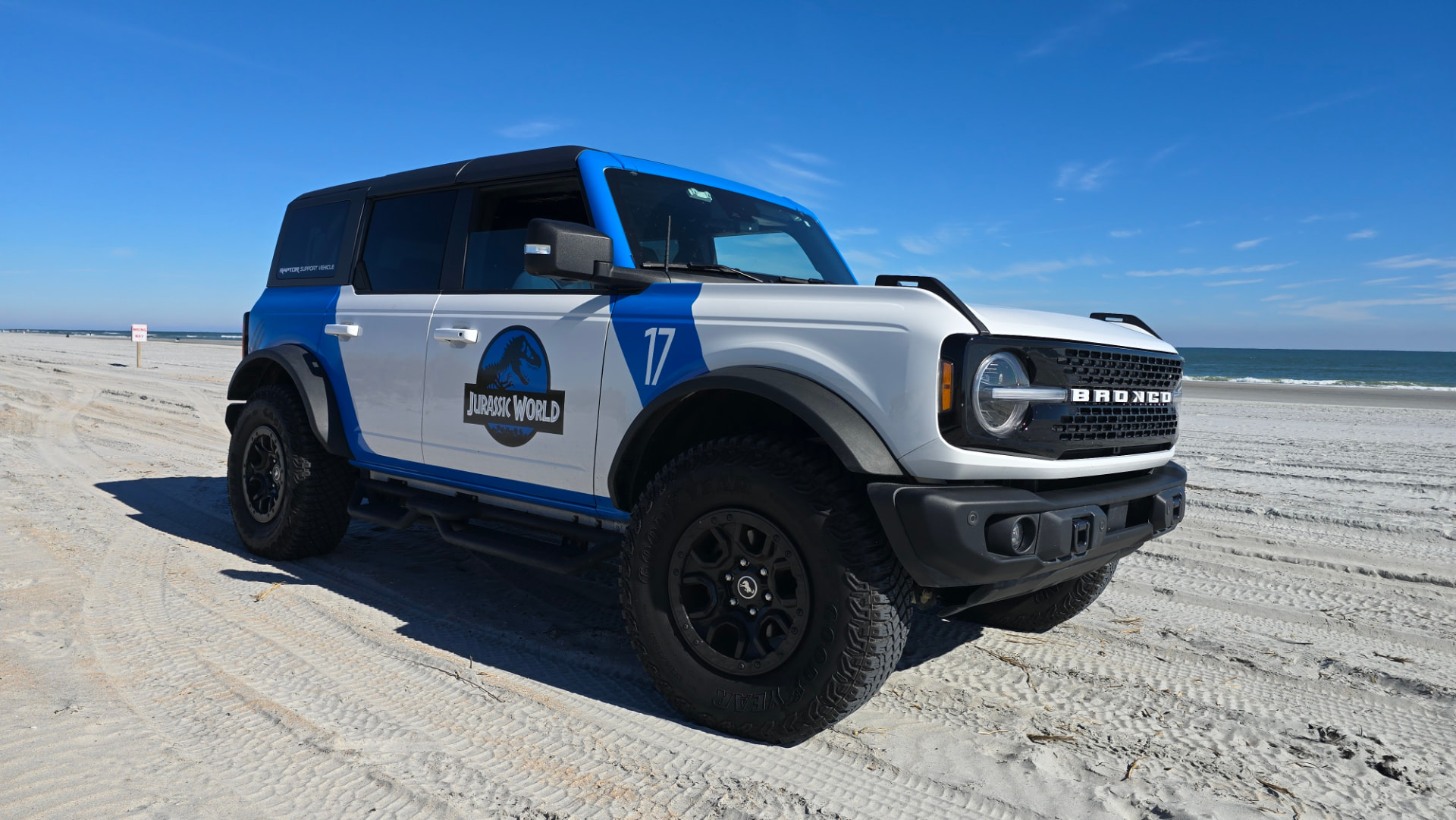 Jurassic World Bronco parked on the beach at the water's edge