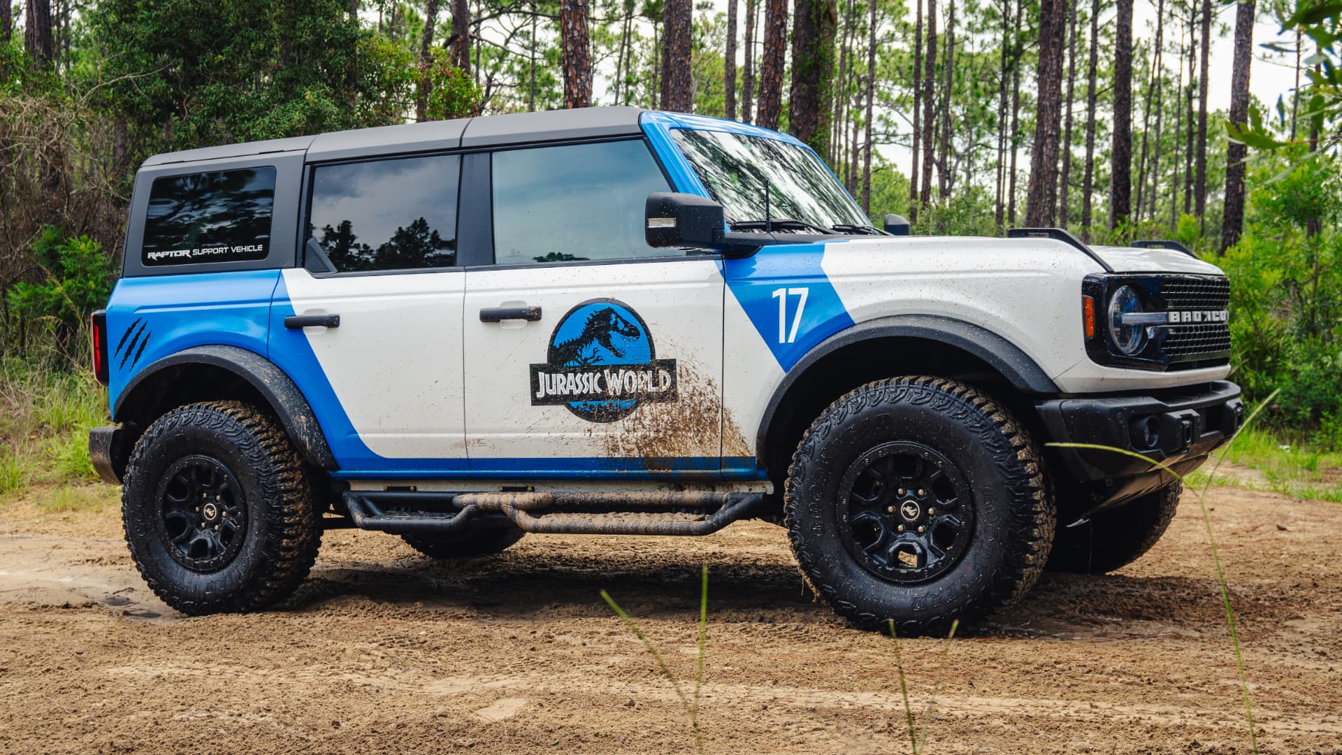 Driver side profile of the Bronco Wildtrak among tall pines