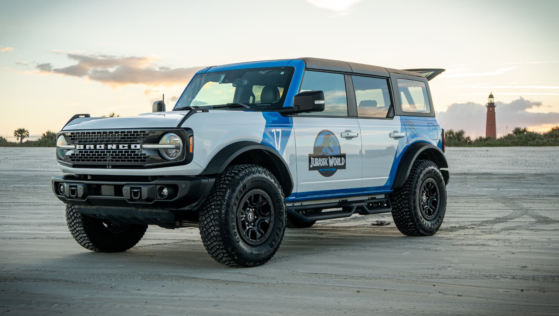 Front three quarter view of the Jurassic World Bronco at sunset with the Ponce Inlet lighthouse behind it